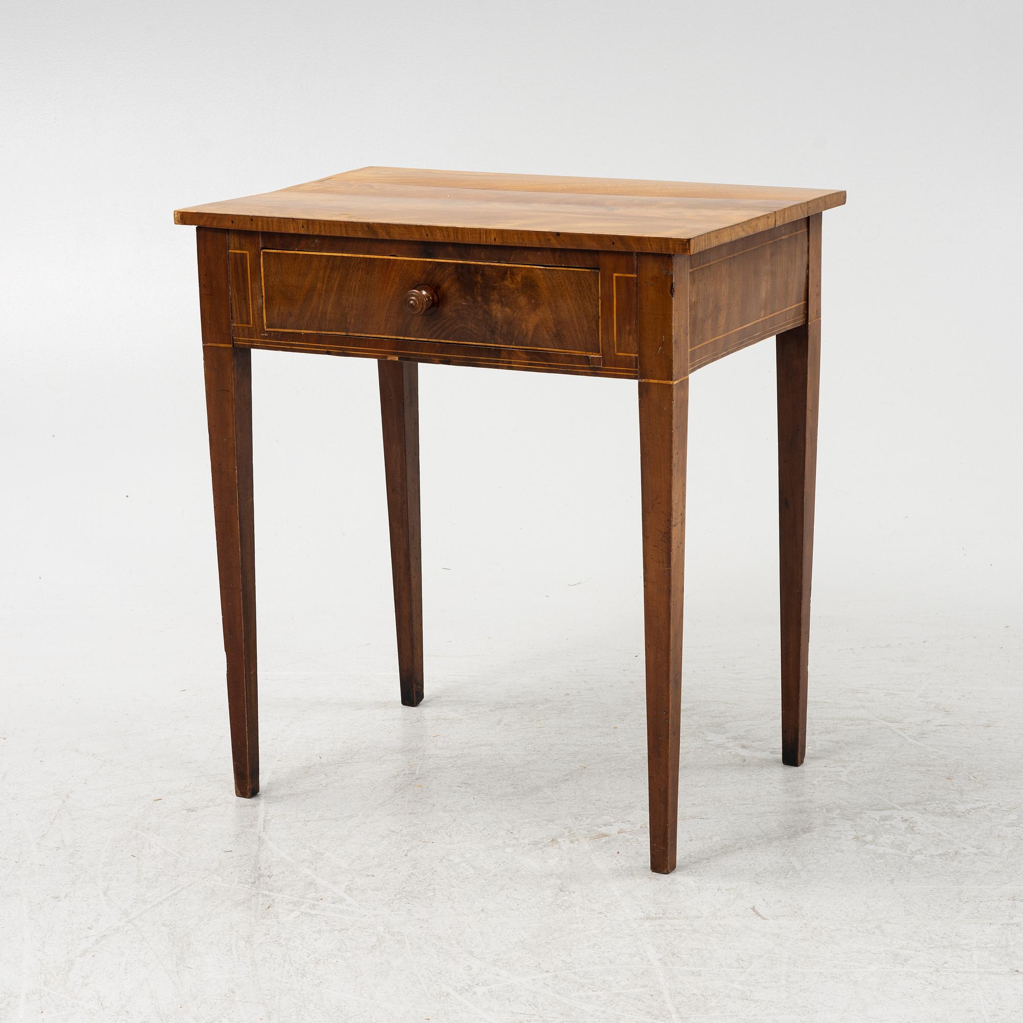 A mahogany veneered table, circa 1800.