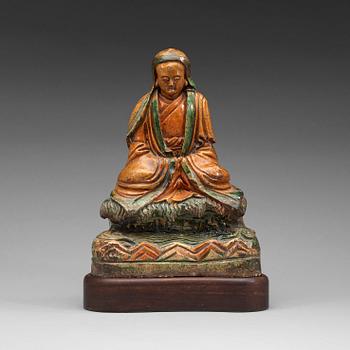 79. A seated green and yellow glazed deity, Ming dynasty (1368-1644).