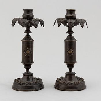 A pair of mid 19th century late Empire candlesticks.