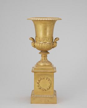 A French Empire bronze urn, early 19th century.