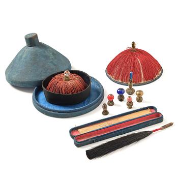 1197. Two boxes with a mandarin's summer hat and black satin autumn hat and feather with six mandarin hat insignias.