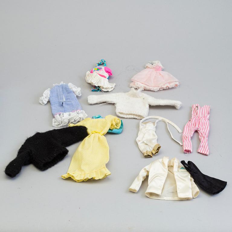 A plastic doll's house with six dolls, furniture and clothes, 20th century.