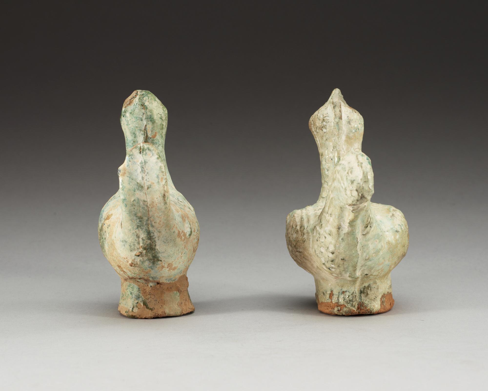 A set of two green glazed pottery models of a rooster and a hen, Han dynasty (206 BC- 220 AD).