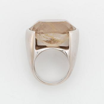 A Tina Karlsson ring in 18K white gold ring set with a faceted rutile quartz.