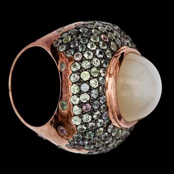 A cabochon cut moonstone and sapphire ring.