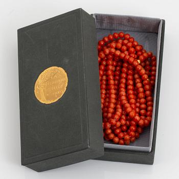 A coral necklace with a 14K gold clasp.