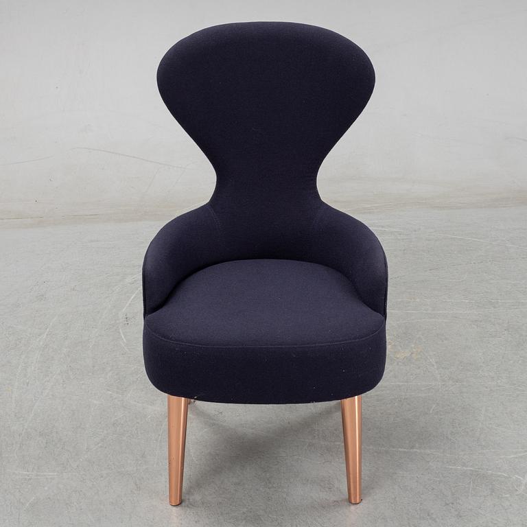 A Tom Dixon "Wingback Dining Chair" from Tom Dixon.
