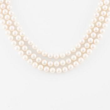 Necklace, pearls, three strands, clasp in 14K white gold with small diamonds.