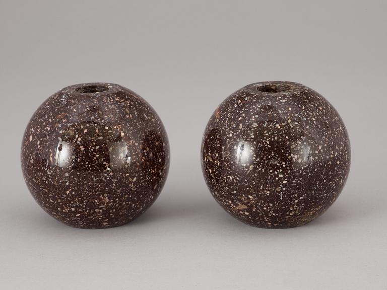 A pair of circa 1900 porphyry candlesticks.