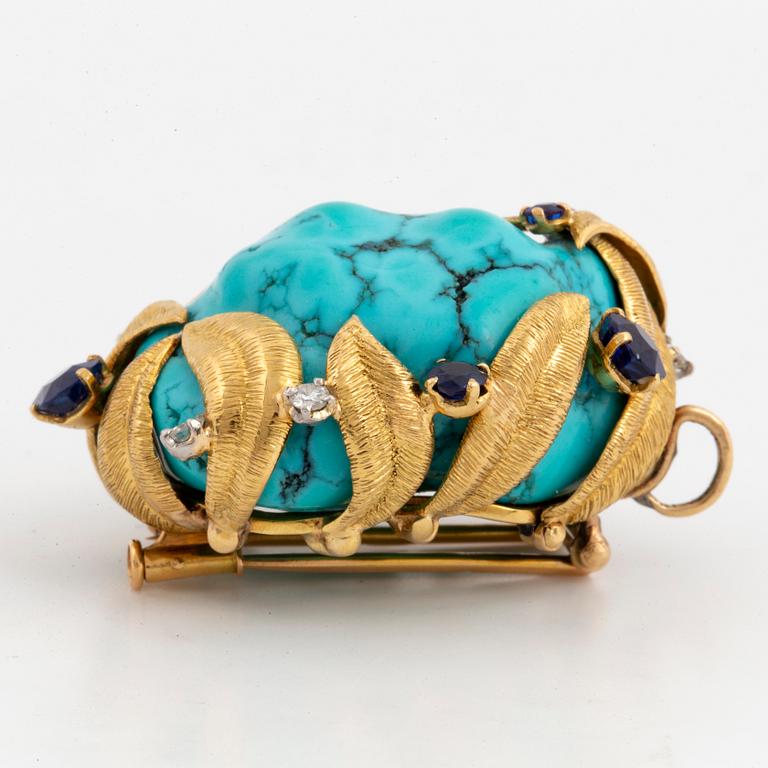 A brooch/pendat, large turquoise with brilliant-cut diamond and sapphires.