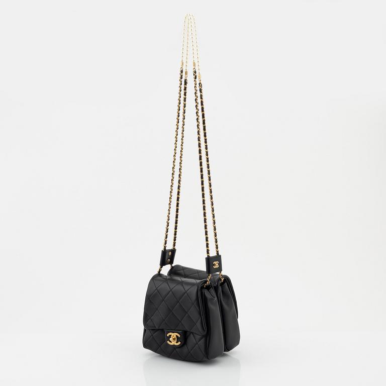 Chanel, a black leather, gold hardware and pearl chain 'Side Pack bag', 2019.