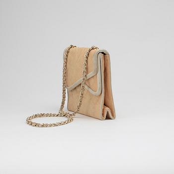 CHANEL, a beige shoulder bag.