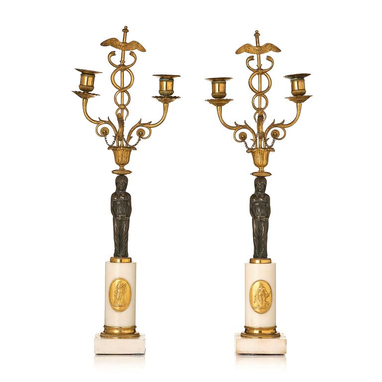 A pair of late Gustavian white marble and bronze candelabra.