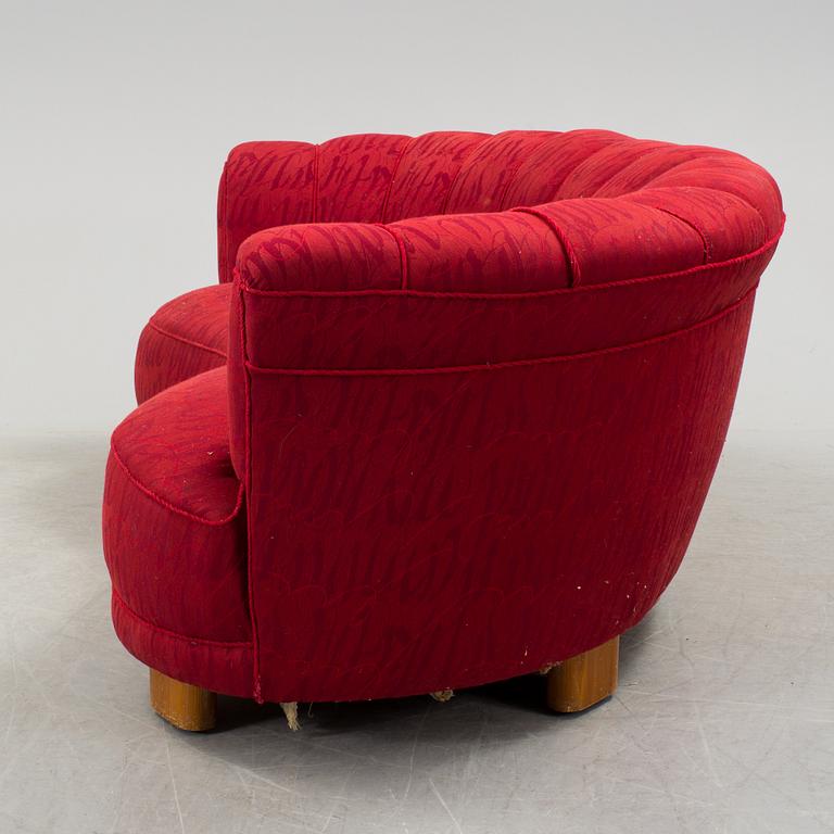 A 1930s curved sofa by Greta Magnusson Grossman for Firma Studio.