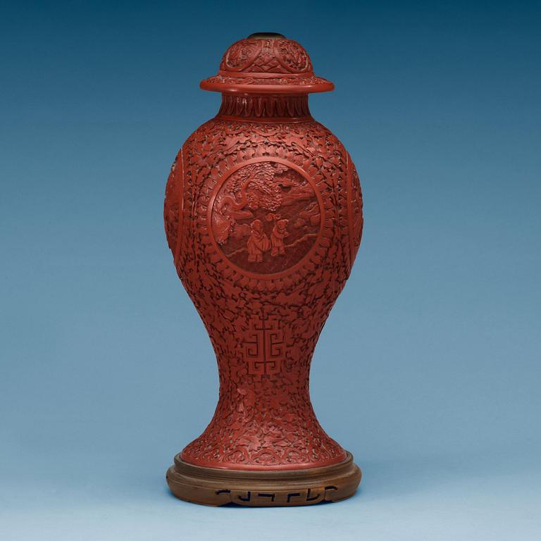 A Chinese red lacquered vase with cover, 20th Century.