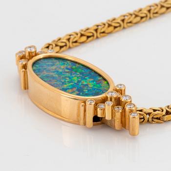 An 18K gold pendant set with an opal and round brilliant-cut diamonds.