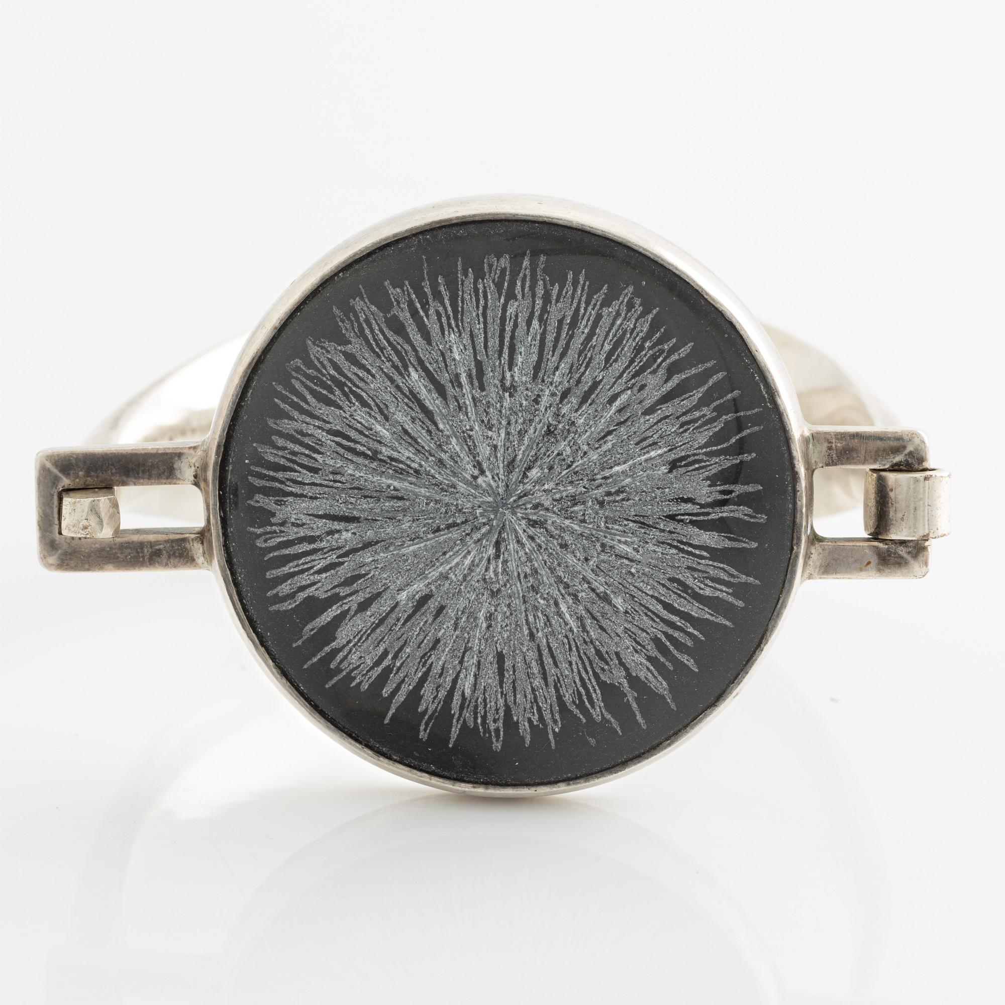 Bangle, silver with inset stone/flower.