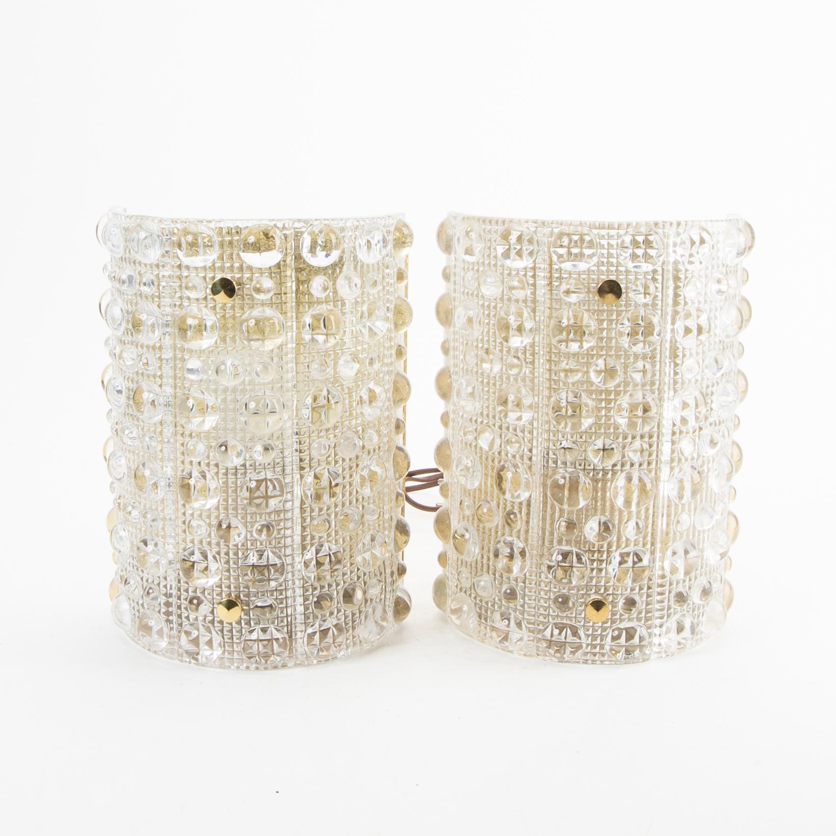 A pair of Carl Fagerlund glass and brass walls cones from Orrefors 1970s.