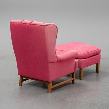 An 'Oxford' model no 3543 easy chair with stool by Ragnar Helsén for Firma Svenskt Tenn.