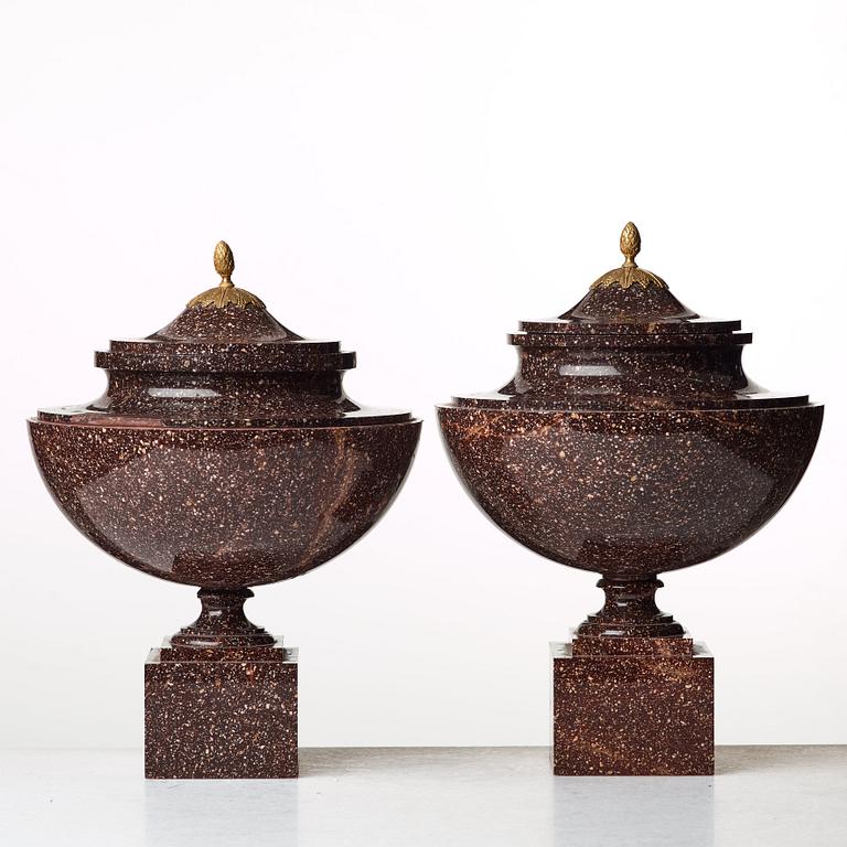 A pair of late Gustavian early 19th century porphyry urns with cover.