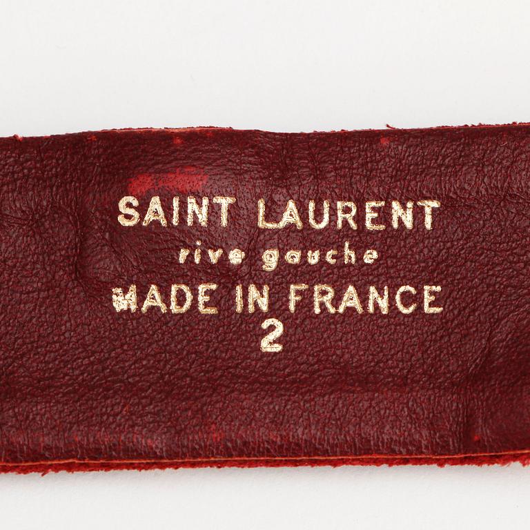 YVES SAINT LAURENT, a red suede belt.