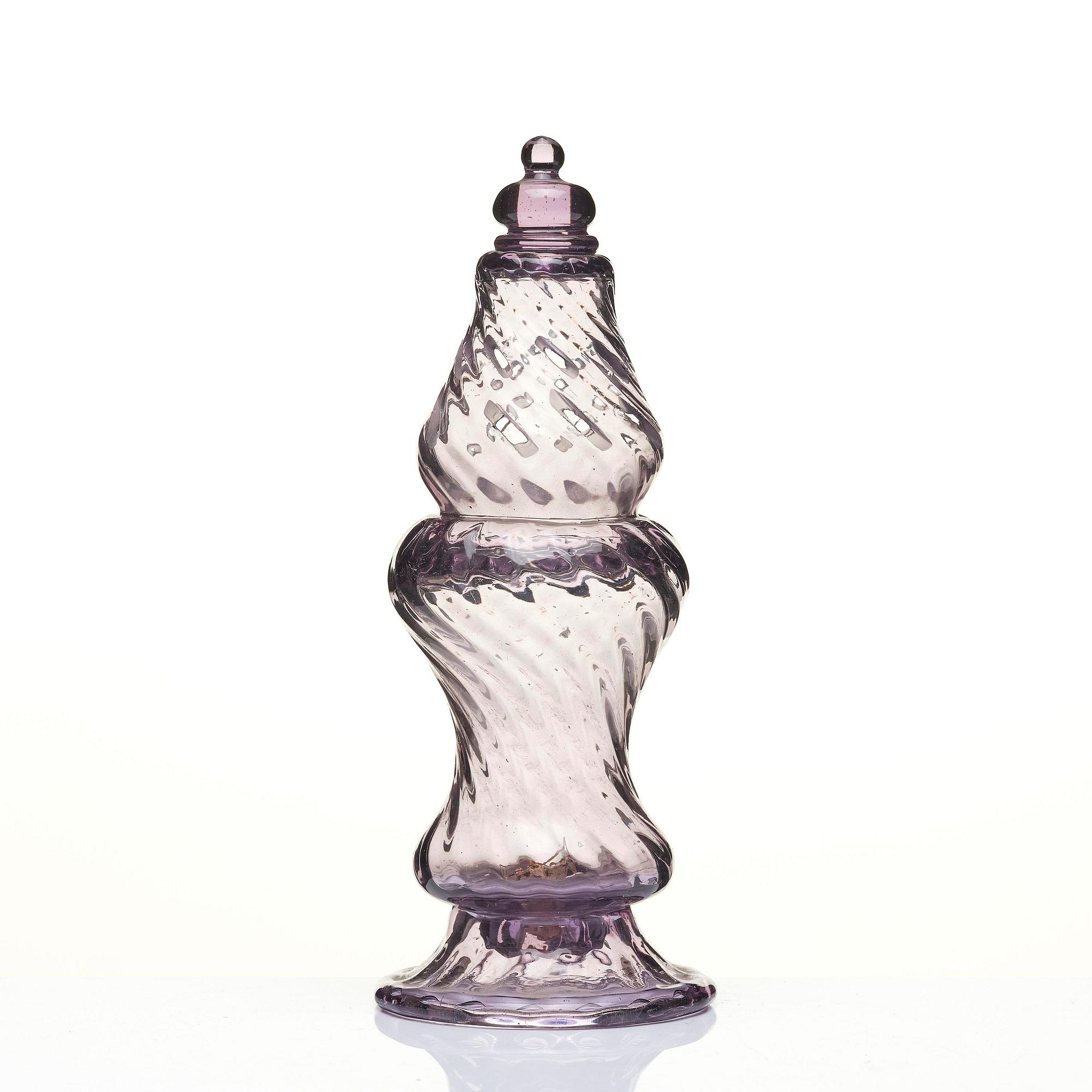 An amethyst coloured suger shaker and a cut glass goblet, 18th century.