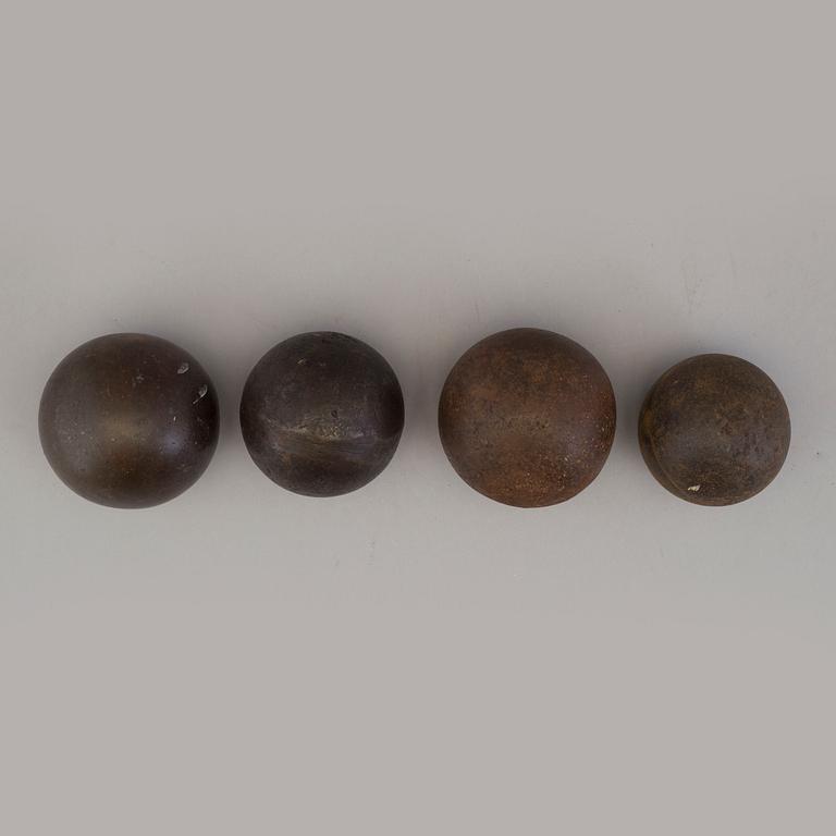 Four iron balls, 18th/19th century.