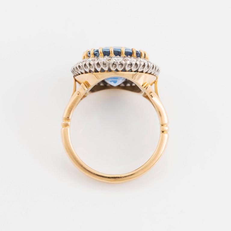 Ring 18K guld med en fasettslipad safir och runda briljantslipade diamanter.