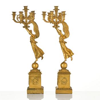 A pair of six-branch gilt bronze Empire candelabra, Paris, early 19th century.