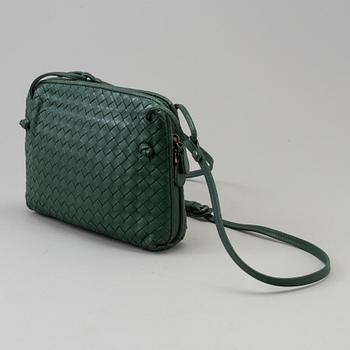 A green Bottega Veneta cross-body  handbag.