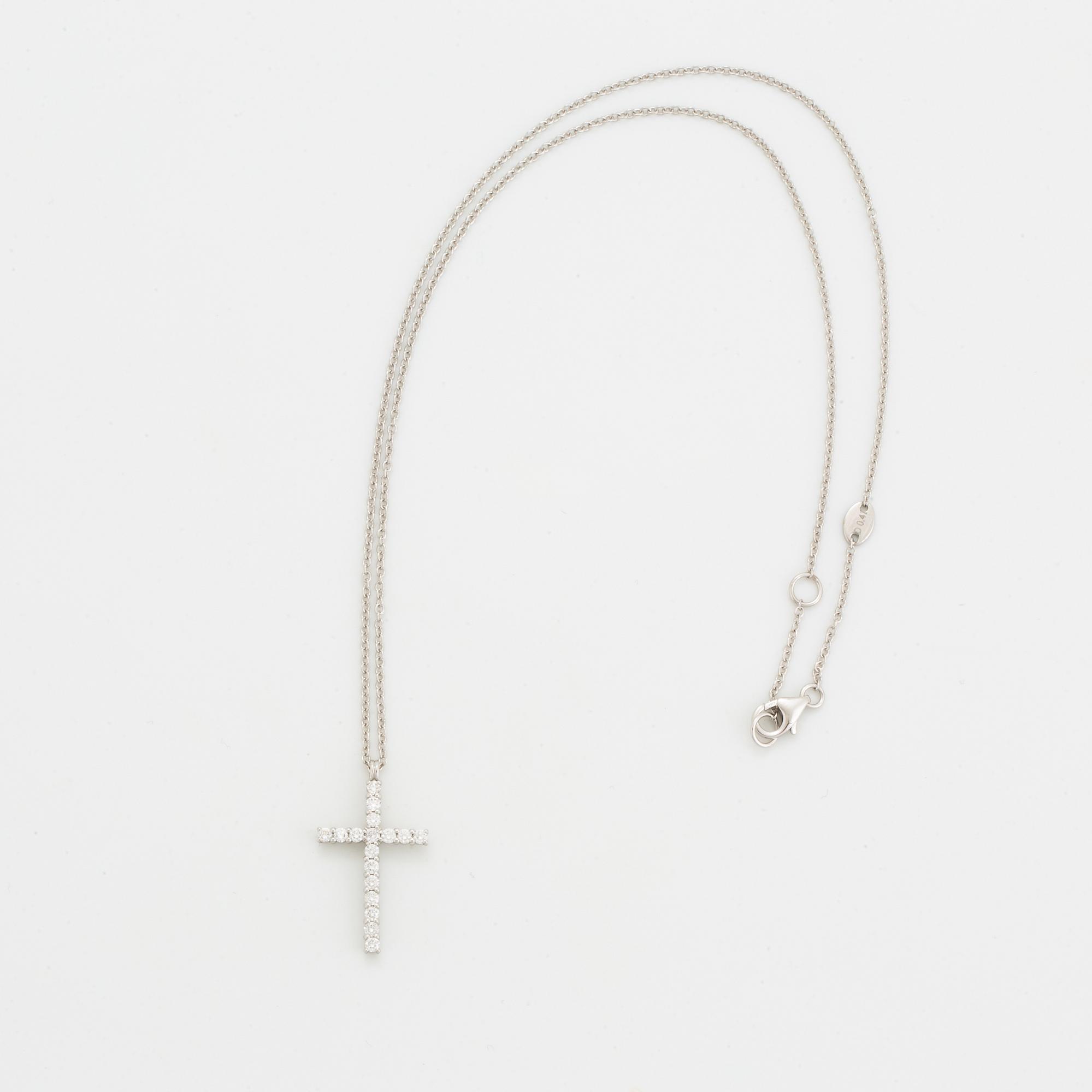 Brilliant-cut diamond cross pendant.