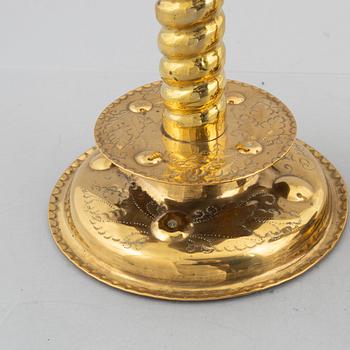 A pair of brass baroque style candlesticks, end of the 19th century.