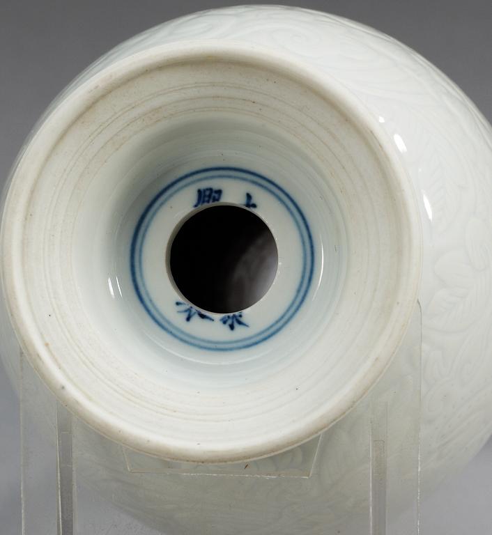 A white glazed vase, Qing dynasty with mark.