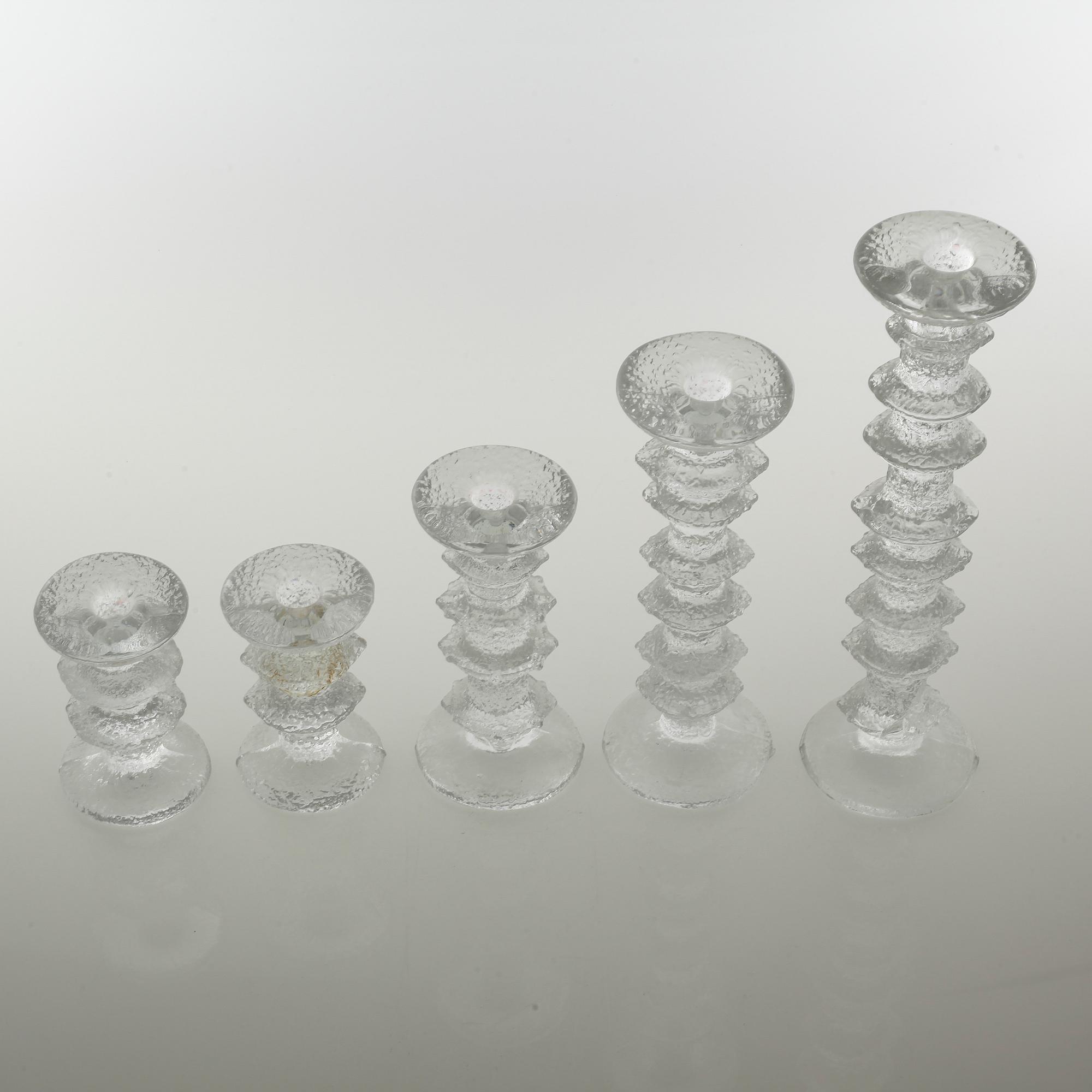 Five glass candlesticks by Timo Sarpaneva for Iittala, model "Festivo", second half of the 20th century.