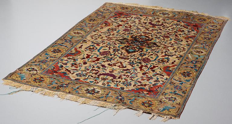 A RUG. An antique silk Kashan so called Motachem. 202,5 x 136,5 cm.