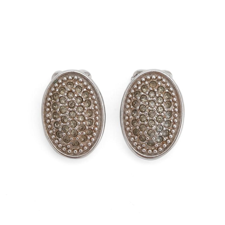 BURBERRY, a pair of silver colored clip earrings.