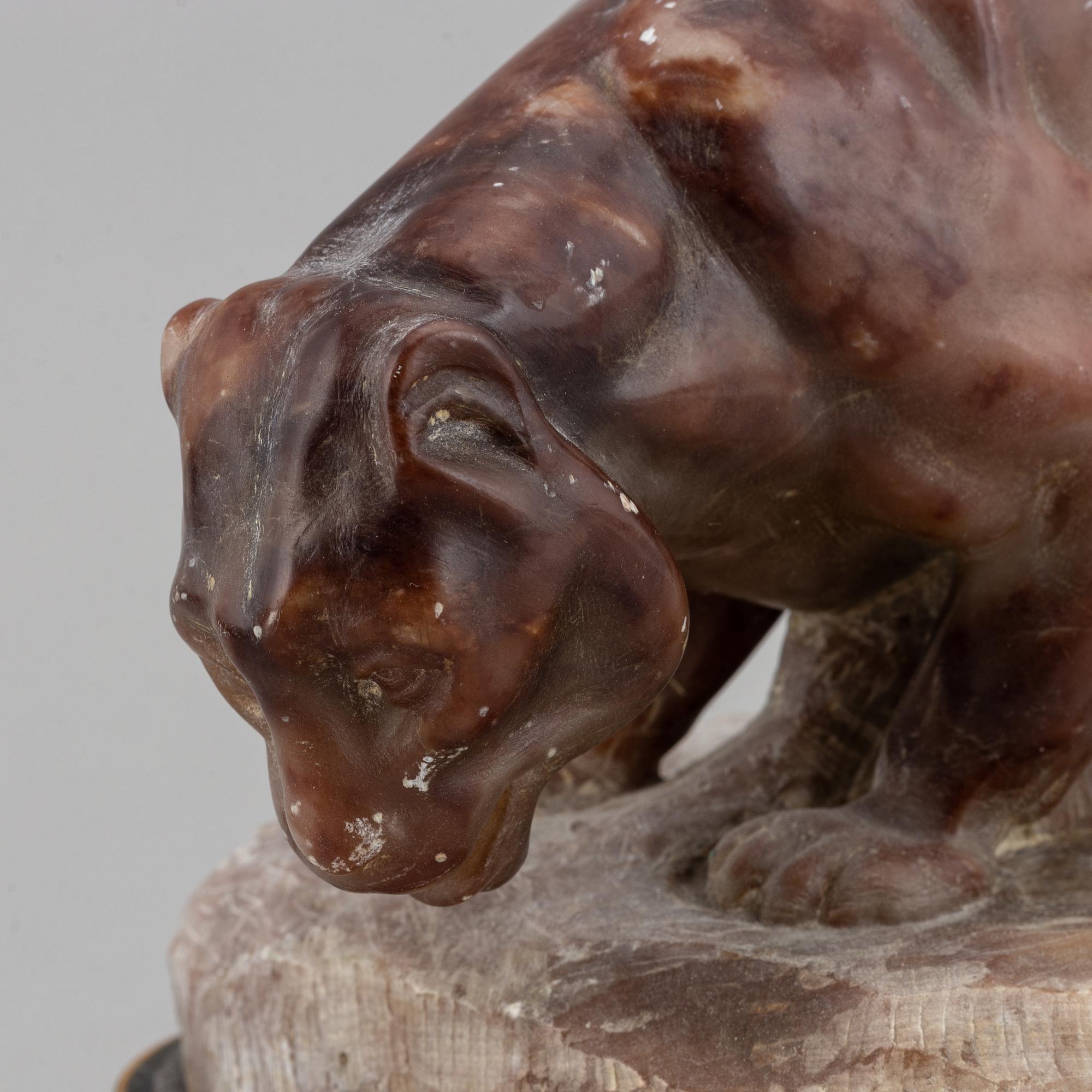 A 20th century stone sculpture of a panther.