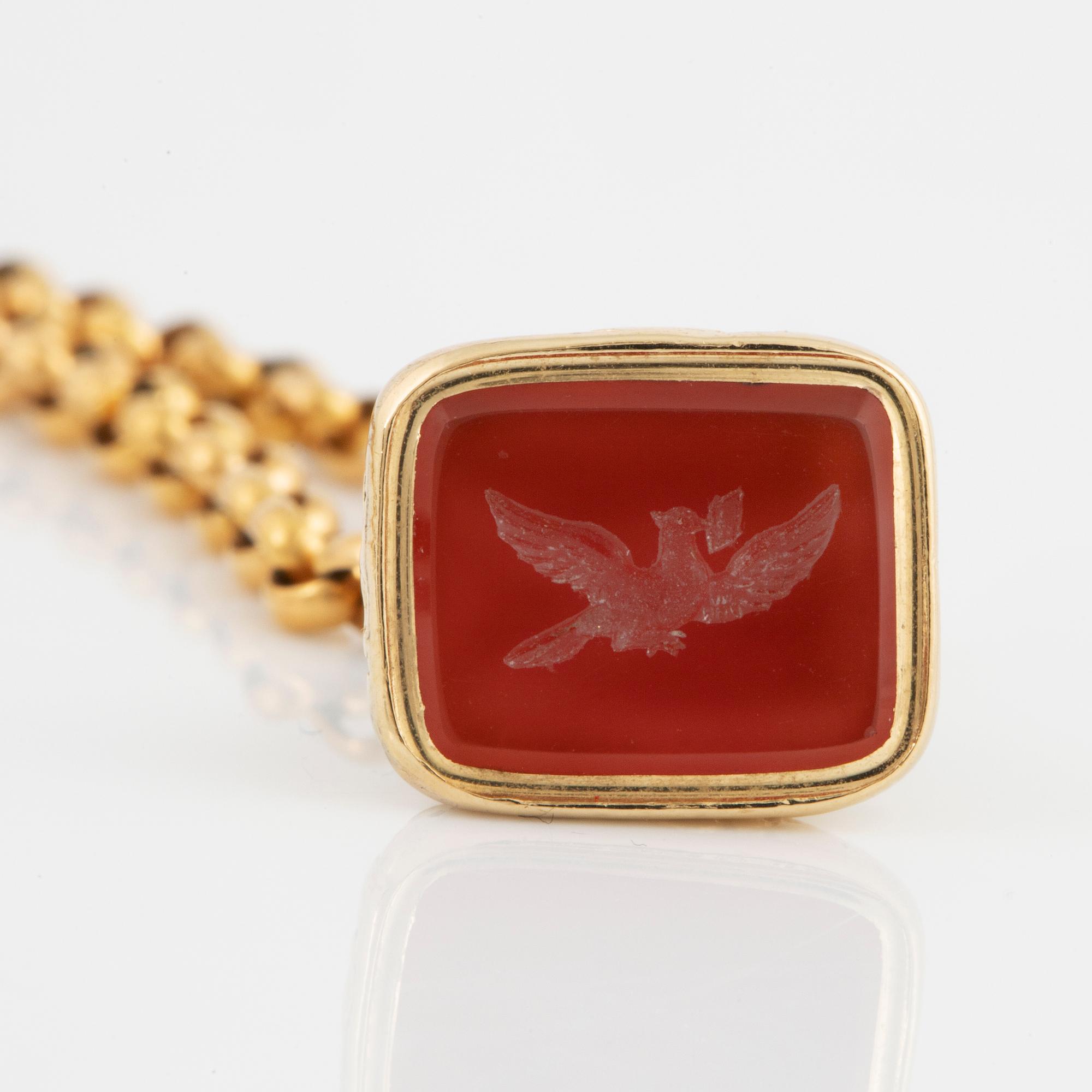 A carnelian seal in a chain.