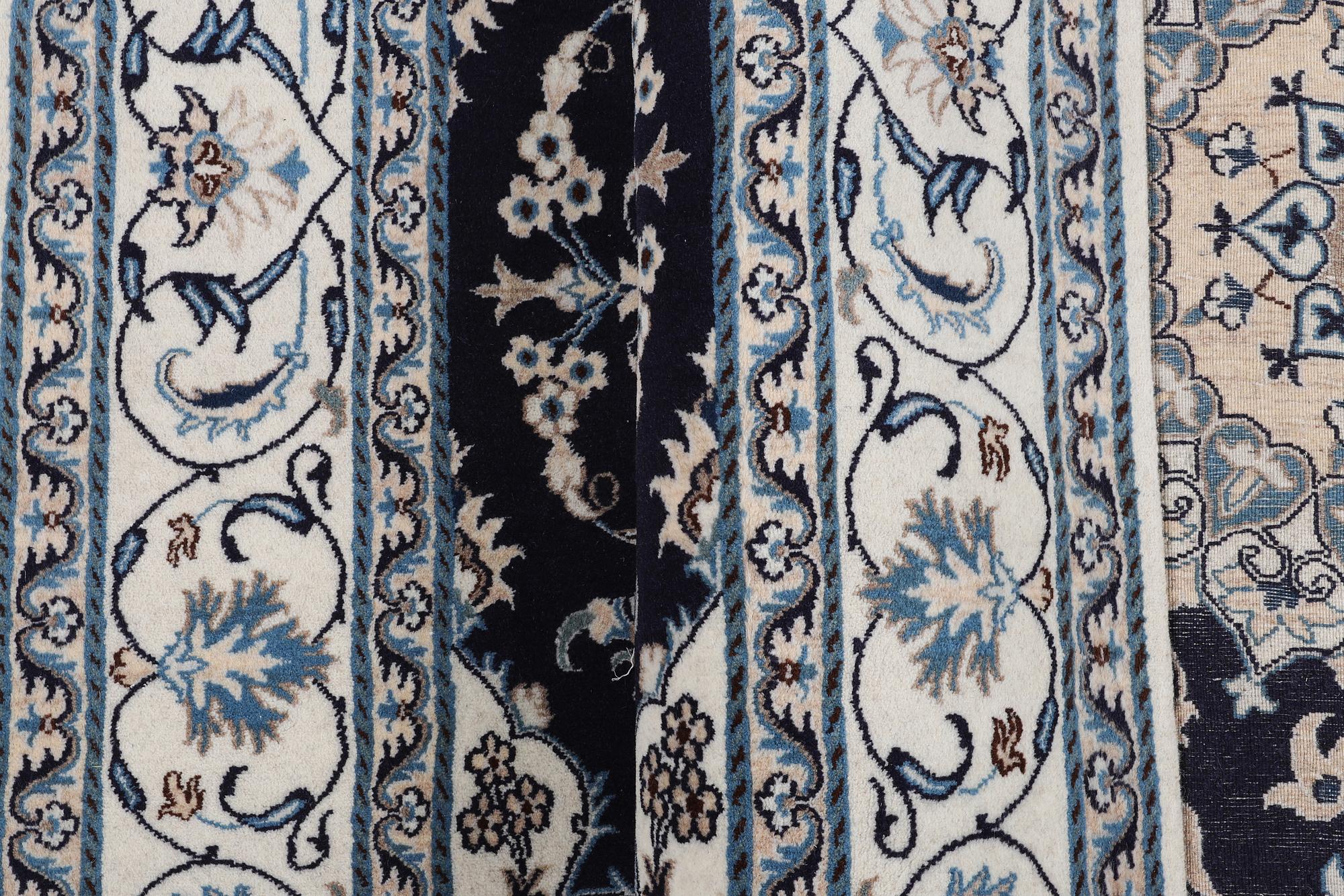 A carpet, Nain, part silk, ca 256 x 199 cm.