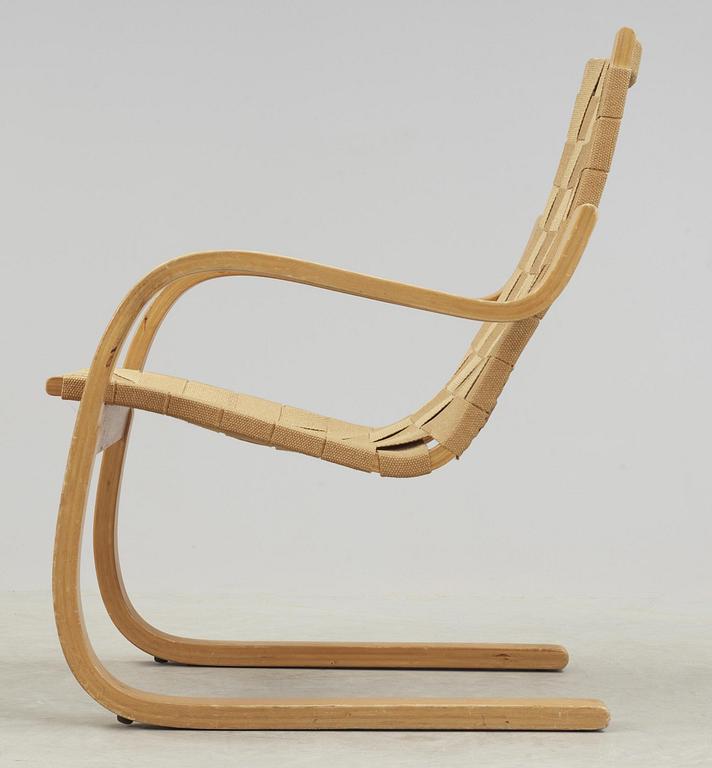 An Alvar Aalto laminated beech and webbing armchair, model 406, Svenska AB Artek, Hedemora, Sweden 1946-56.