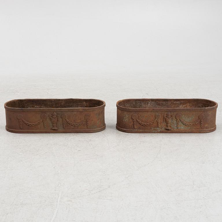 A pair of cast iron planters, 20th Century.