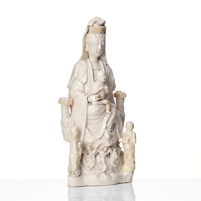 A Chinese blanc de chine Guanyin with attendants, Dehua, late Ming dynasty/early Qing dynasty.