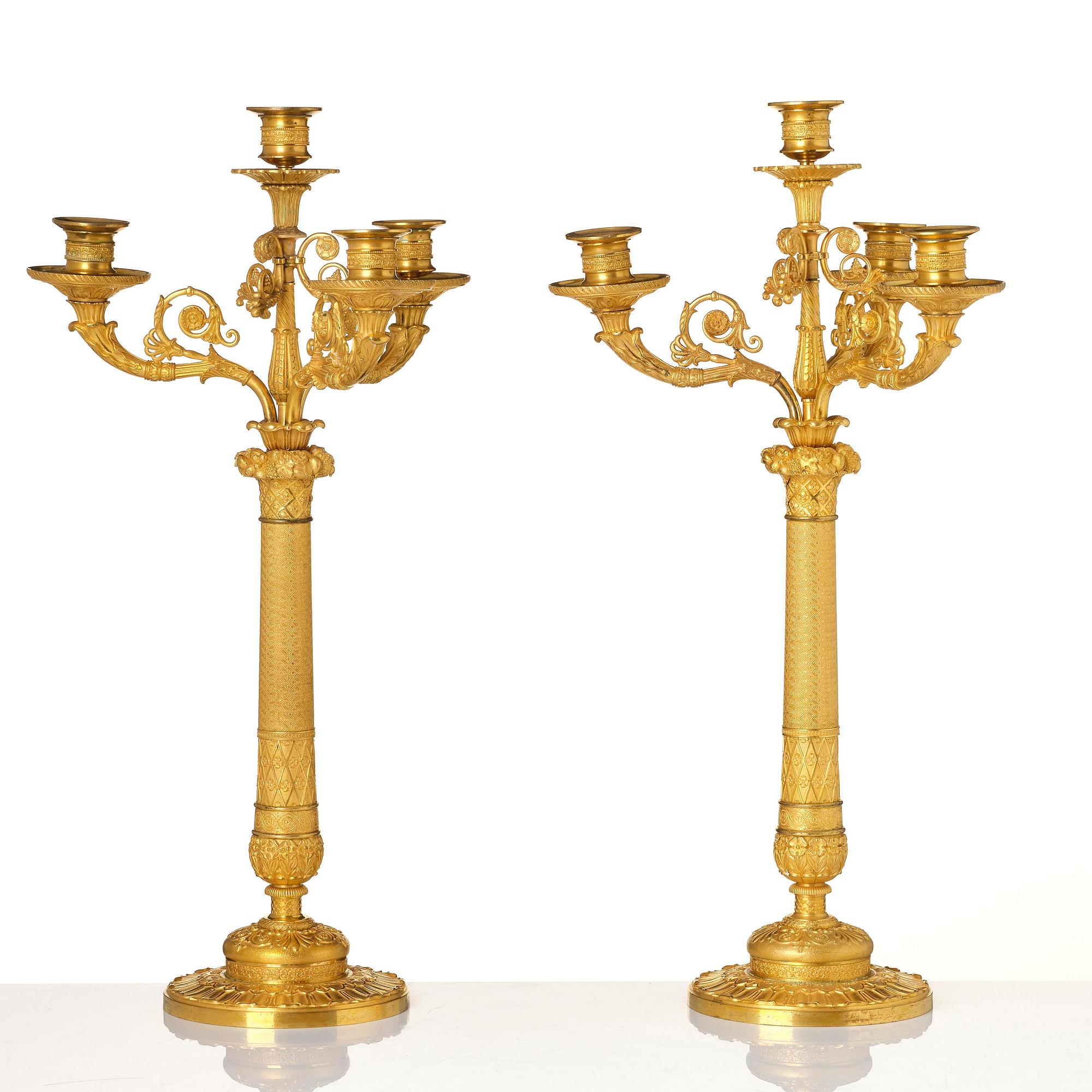 A pair of French Empire four-light gilt bronze candelabra, early 19th century.