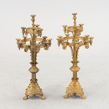 Two similar 19th century bronze candelabras.