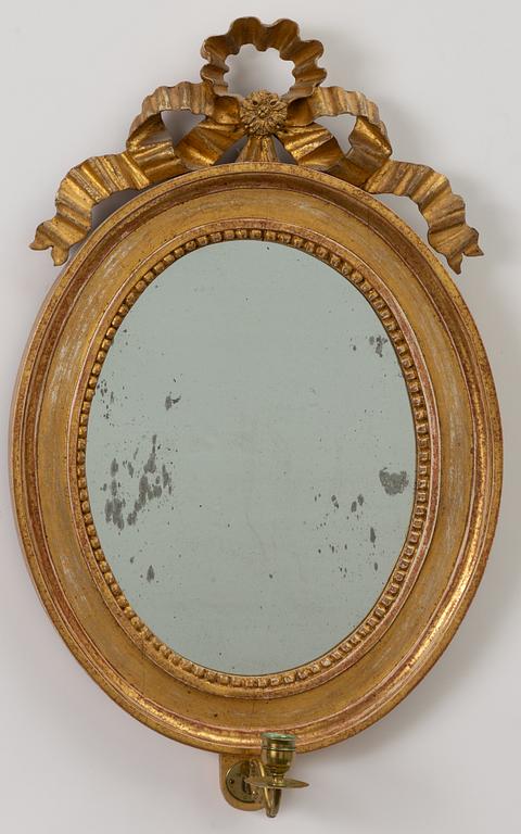 A pair of late Gustavian one-branch giltwood girandole mirrors, Stockholm, circa 1800.