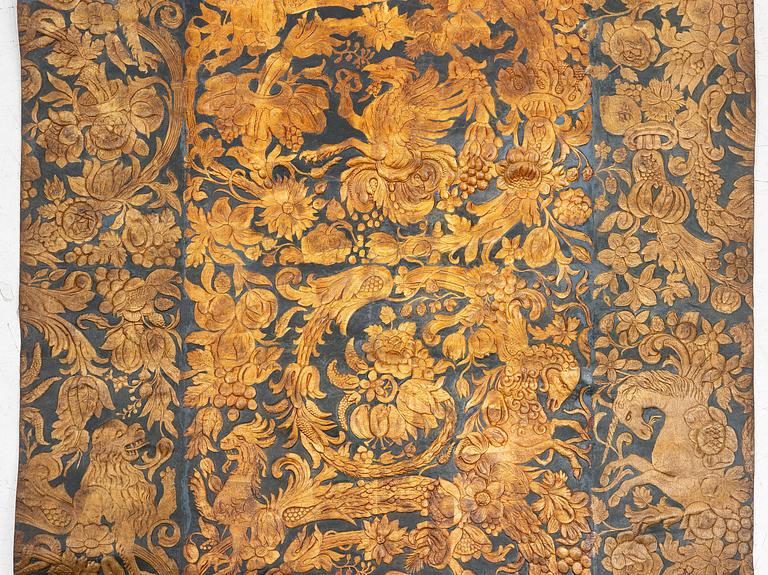A 19th century wrought leather wallpaper, ca 388 x 97 cm.