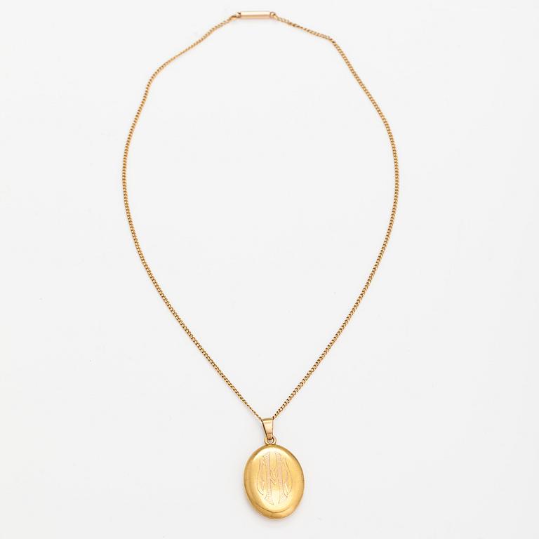 A 14K gold necklace with a medallion.