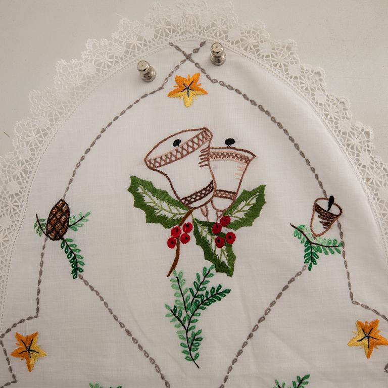 A collection of smaller Christmas tablecloths, runners, and wall hangings, approximately 34 pieces, mid/second half of the 20th century.