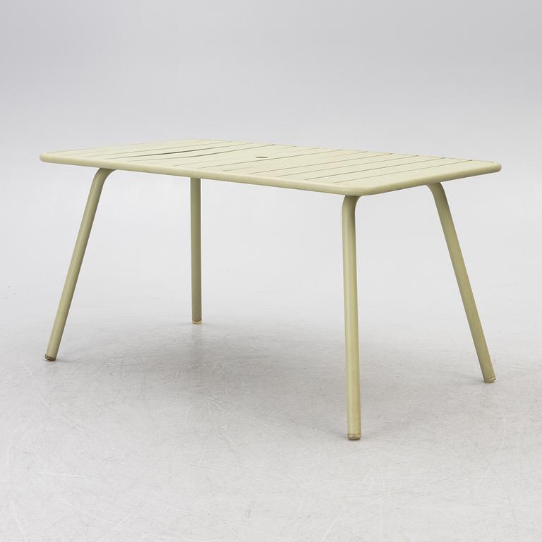Frédéric Sofia, a table and two chairs for outdoor use, "Luxembourg" Fermob, France, 21st century.
