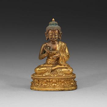 A partly gilt Tibeto-Chinese figure of Maitreya Buddha, 18th century.